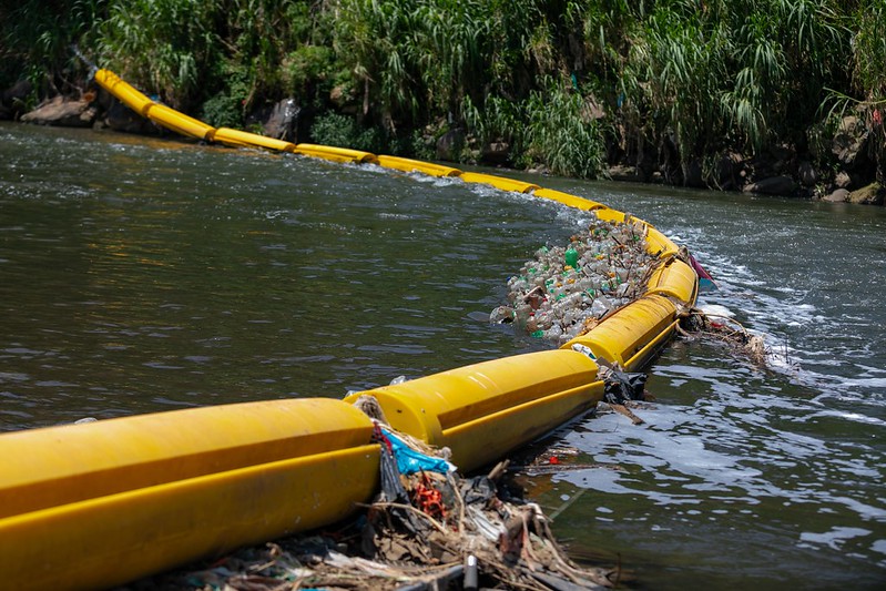 The plastic barrier across the River Virilla.