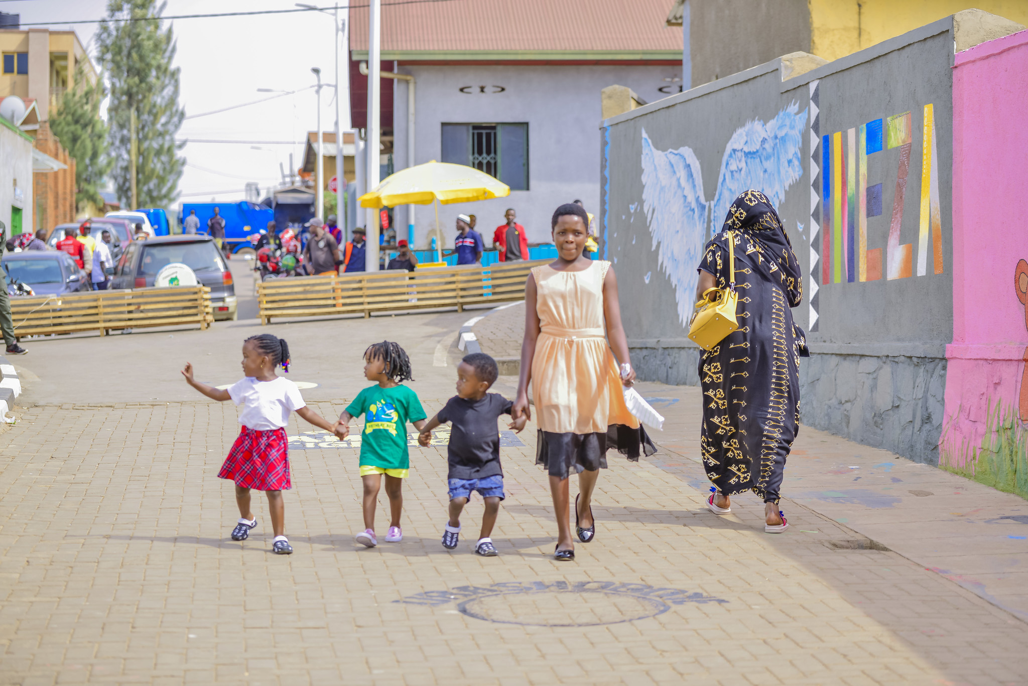 Girl and children walking on pedestrian street in Kigali, Rwanda