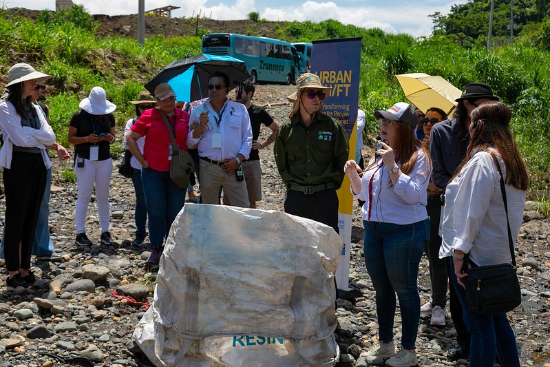 Ana Yancy Arce of Corporation Pedregal explains the plastic barrier in the River Virilla
