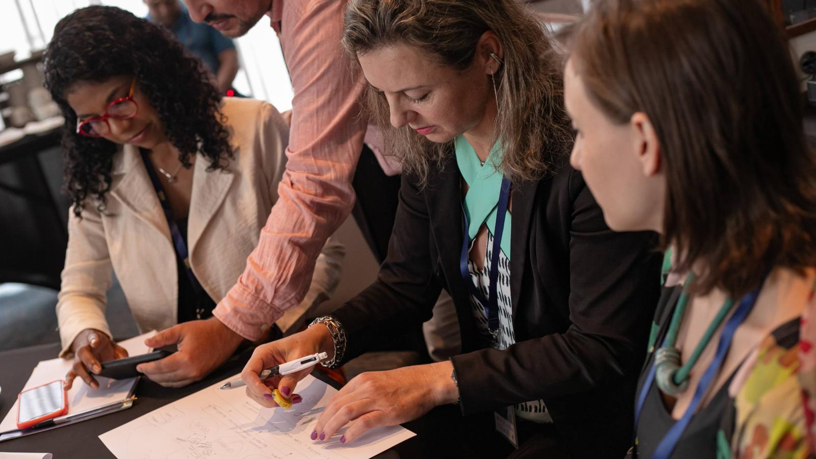 Women working on city academy course materials