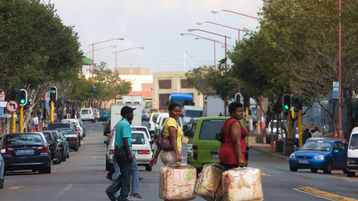 People crossing busy street in Johannesburg South Africa