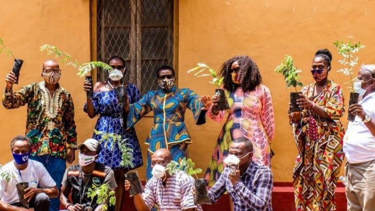 A group of Freetown residents pose with their seedlings