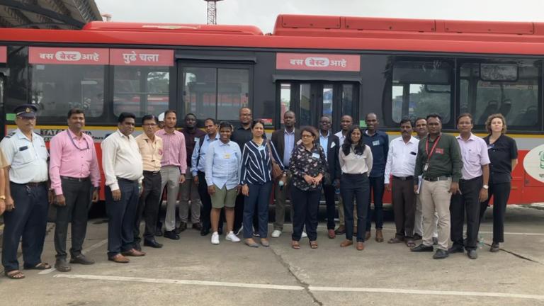 The UrbanShift Peer to Peer exchange participants in front of a zero-emission bus in Mumbai