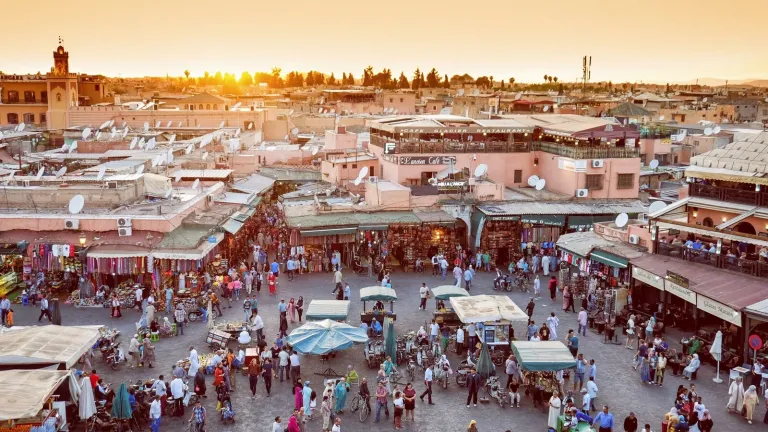 a photograph of a busy city marketplash at sunset