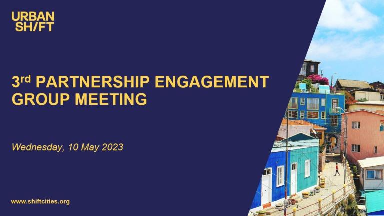 a slide that reads 3rd partnership engagement group meeting against a navy blue background; a image of brightly colored buildings is to the right