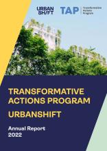 The cover of the Transformative Actions Program UrbanShift 2022 Annual Report. A photograph of a building with trees in the front is bordered by yellow, blue, and pale green blocks.